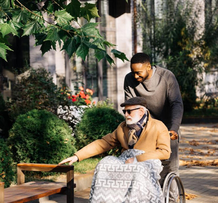 Senior being pushed in wheelchair
